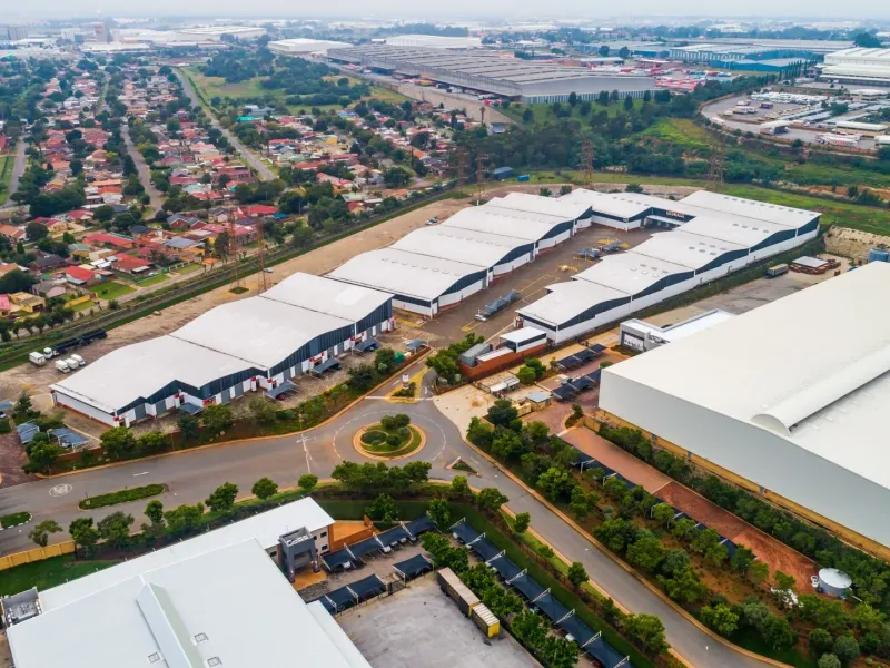 Aerial view of a large-scale industrial warehouse complex featuring multiple units, extensive loading areas, and integrated road infrastructure within a business park setting.