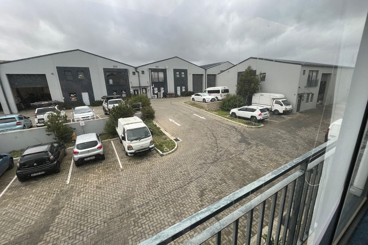 Elevated view of an industrial complex courtyard featuring paved parking areas and multiple commercial unit facades.