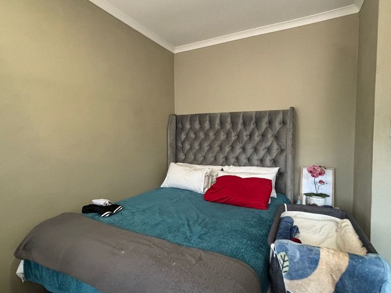A standard bedroom featuring neutral wall paint and coving, providing a functional space for rest.