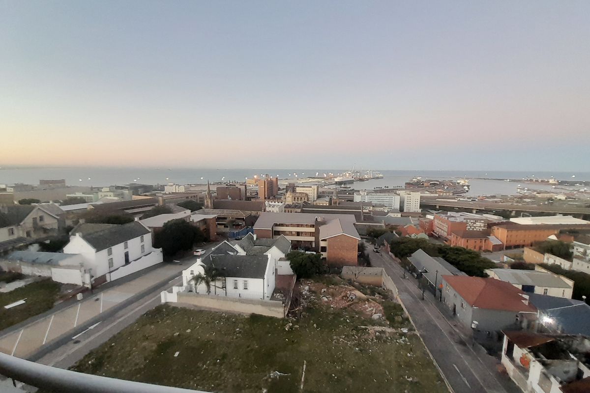 Elevated panoramic view overlooking the surrounding urban landscape, harbor, and coastline.