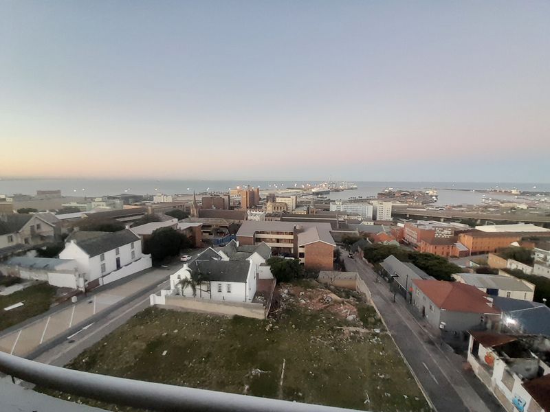 Elevated panoramic view overlooking the surrounding urban landscape, harbor, and coastline.