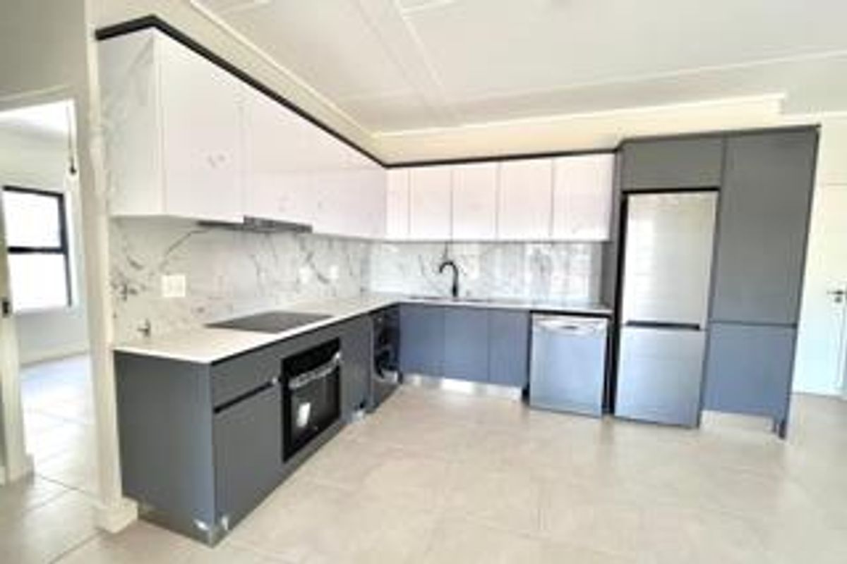 Modern kitchen featuring sleek two-tone cabinetry, marble-look splashbacks, integrated appliances, and high-quality finishes in a clean, contemporary layout.