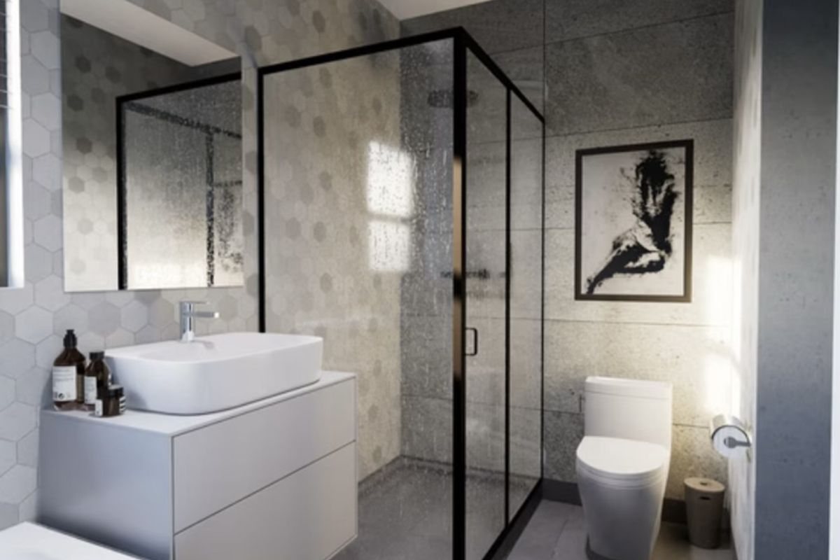 Modern bathroom featuring a glass-enclosed shower, wall-mounted vanity with vessel sink, and contemporary grey hexagonal and large-format tile finishes.
