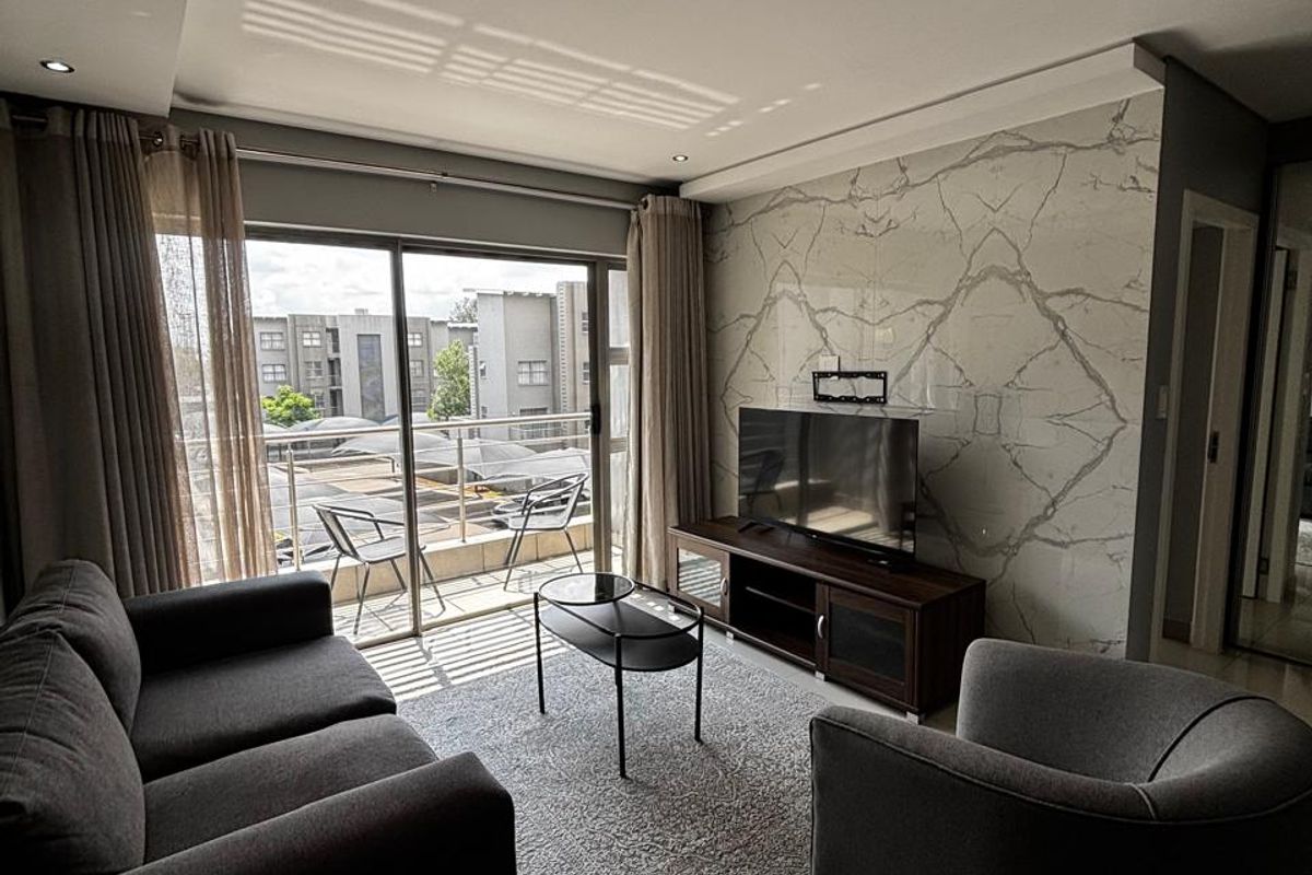 Modern living room featuring a marble-look feature wall, tiled flooring, recessed lighting, and a large sliding glass door leading to a balcony.
