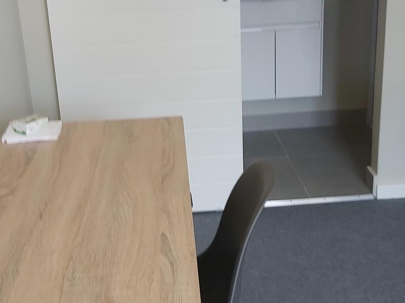 A bedroom featuring a sliding door leading to an en-suite bathroom with a modern vanity and basin.