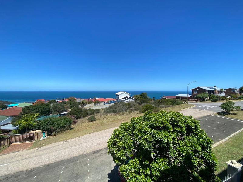 A scenic elevated view overlooking the coastal neighbourhood and the ocean horizon.