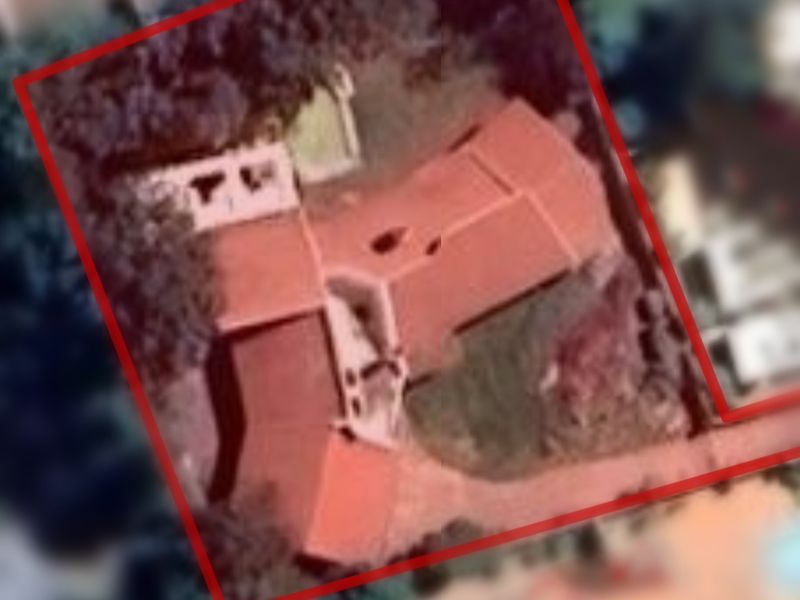 An aerial satellite view of the property showing the roof structure and site boundaries.