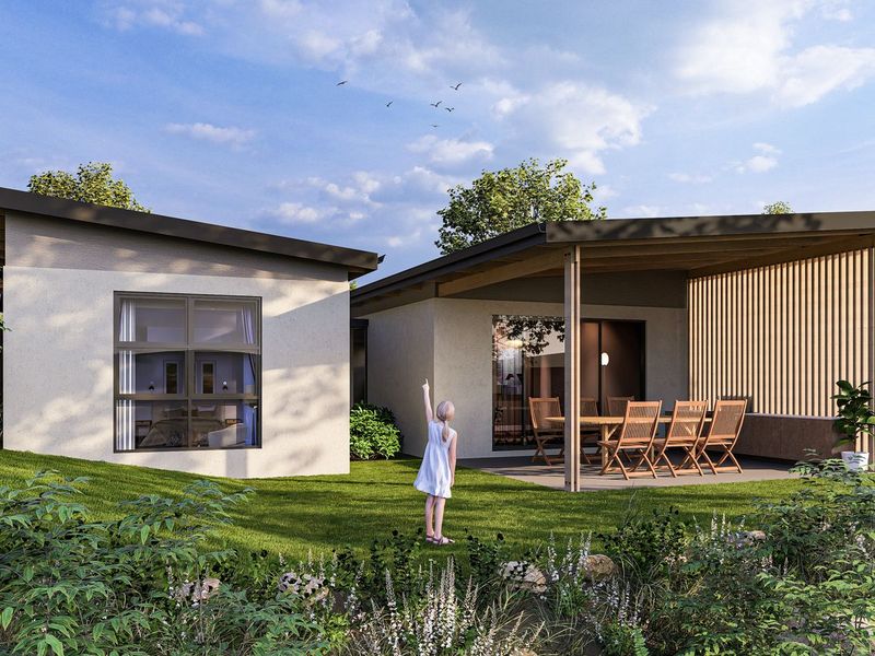 A modern rear exterior view featuring a covered patio with timber slat detailing, sliding glass doors, and a well-maintained landscaped garden.