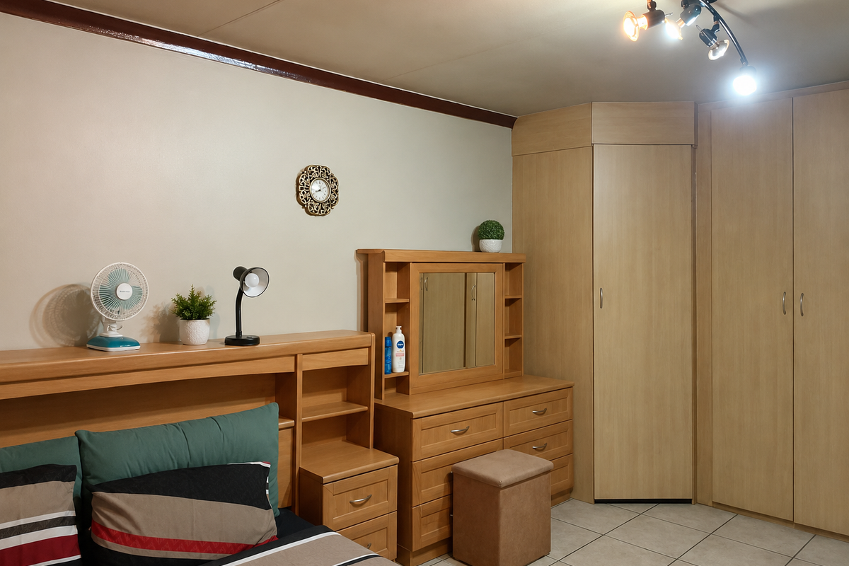 A bedroom featuring built-in wooden cupboards, tiled flooring, and a modern ceiling spotlight fixture.
