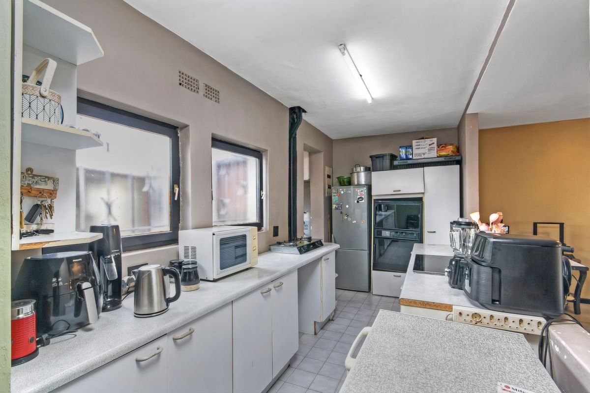 Functional kitchen featuring laminate countertops, built-in oven, and ample cabinetry, offering a practical layout for daily meal preparation.