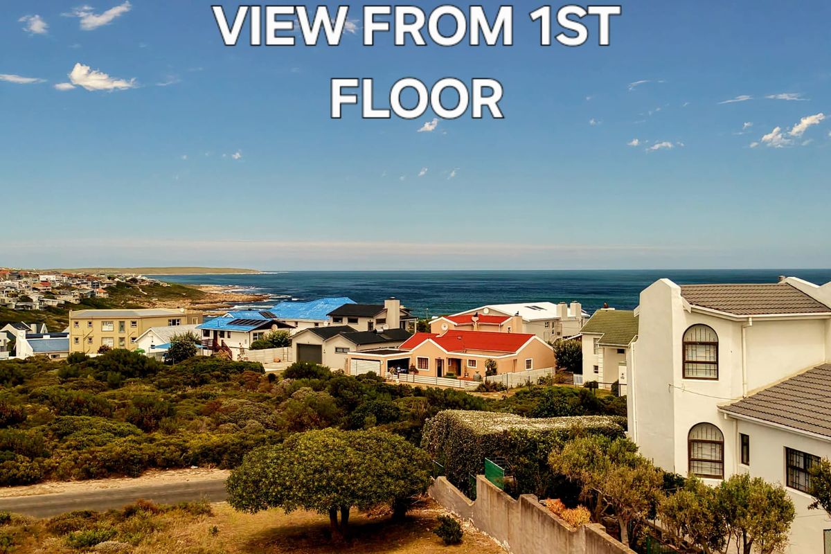 A scenic elevated view overlooking the coastal neighborhood and the ocean horizon.