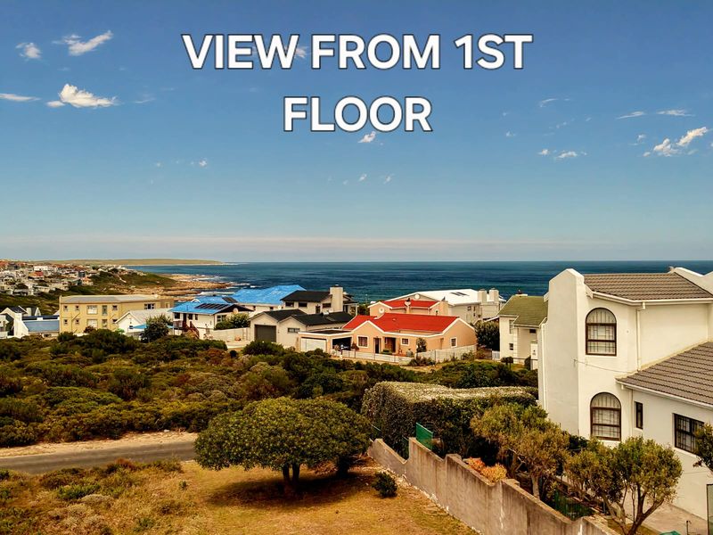 A scenic elevated view overlooking the coastal neighborhood and the ocean horizon.