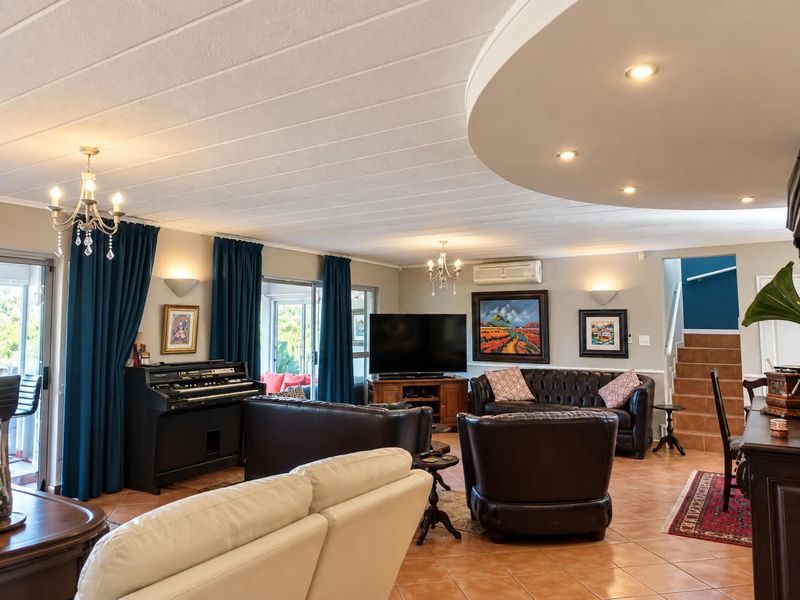 Spacious living room featuring tiled flooring, recessed ceiling lighting, split-system air conditioning, and direct access to outdoor areas through sliding glass doors.