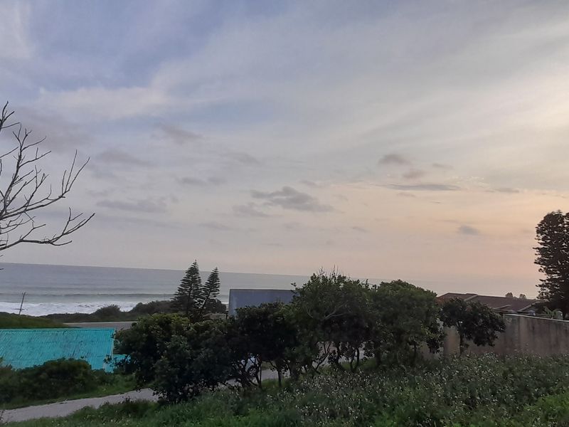 A scenic view overlooking the ocean and surrounding coastal landscape at sunset.