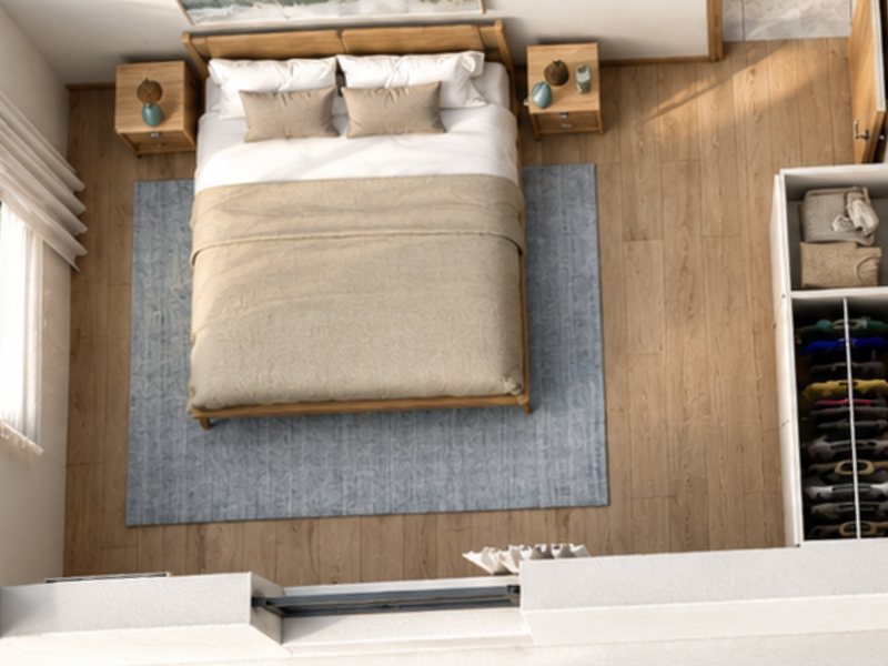 An overhead view of a modern bedroom featuring timber-look flooring, a built-in wardrobe, and large windows providing natural light.