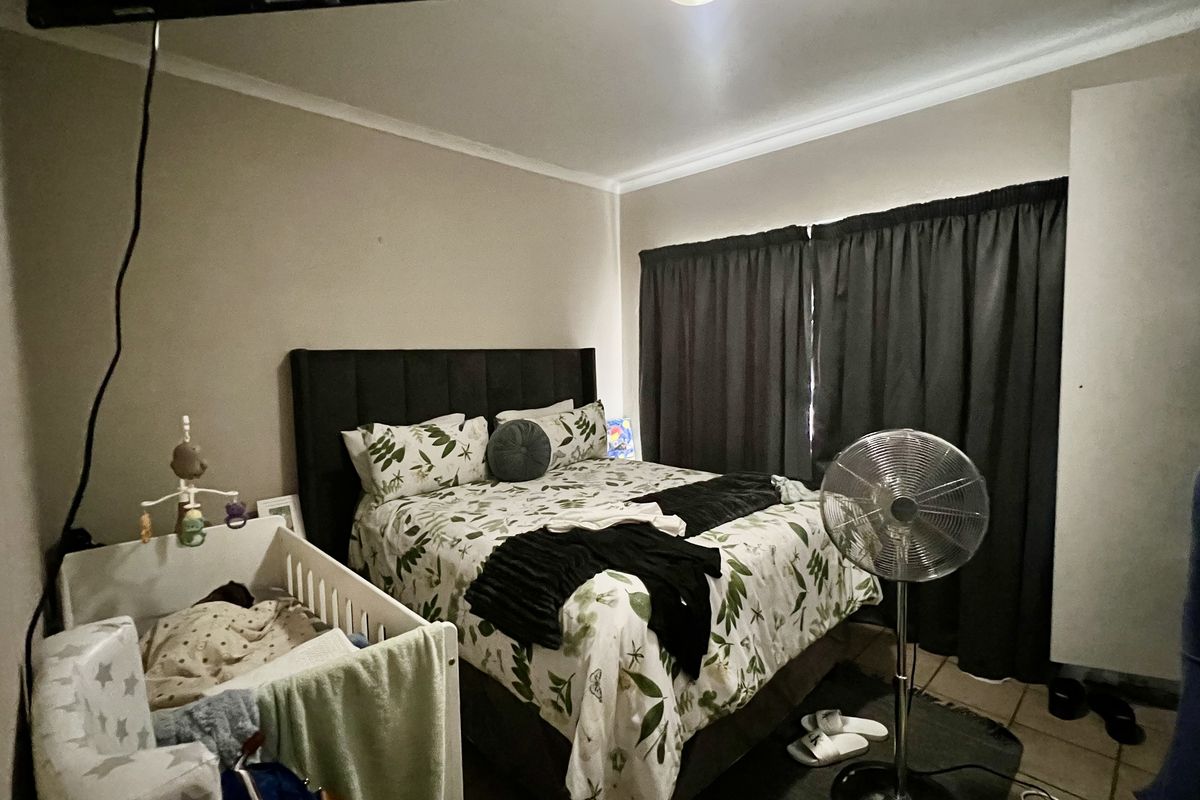 A standard bedroom featuring neutral walls, coving, and a built-in wardrobe, providing a functional space for rest.