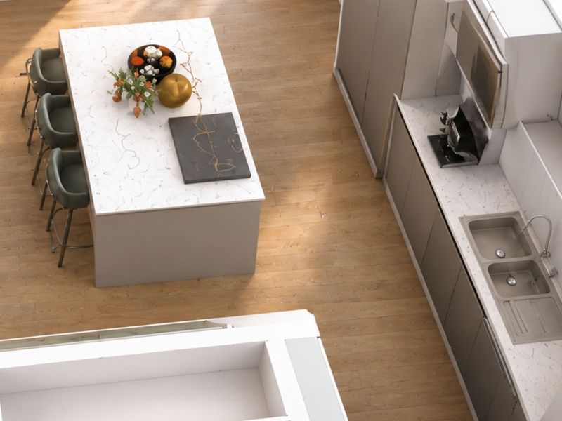 Modern kitchen featuring a central island with quartz countertops, sleek cabinetry, and a double bowl sink, set against light wood-look flooring.