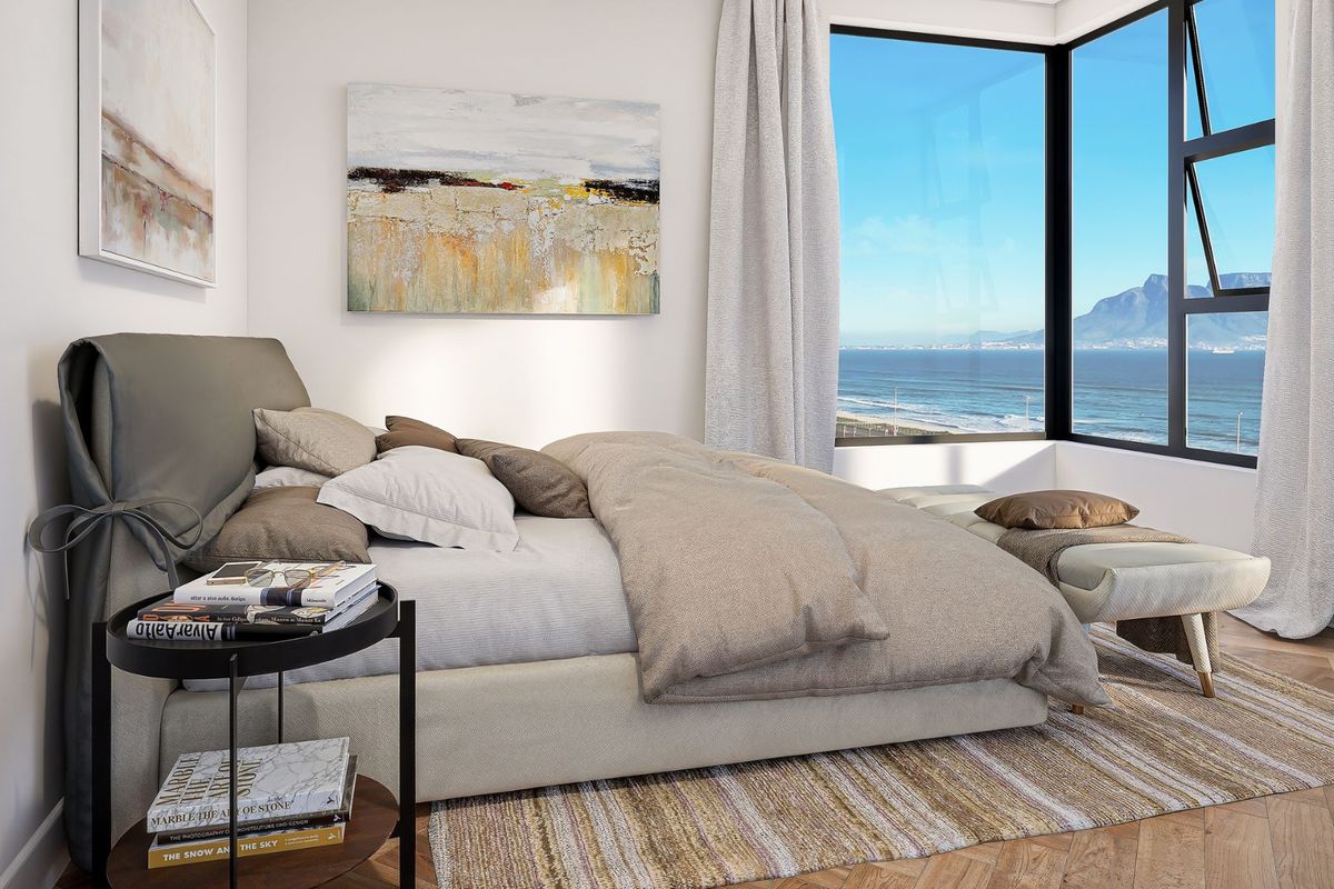 A modern bedroom featuring herringbone timber flooring and a large corner window offering expansive ocean and mountain views.