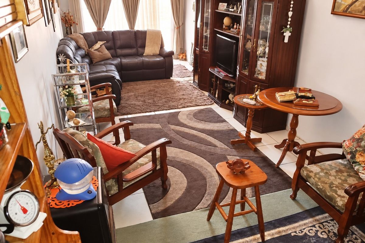 A living room area featuring tiled flooring and a sliding glass door leading to the exterior.