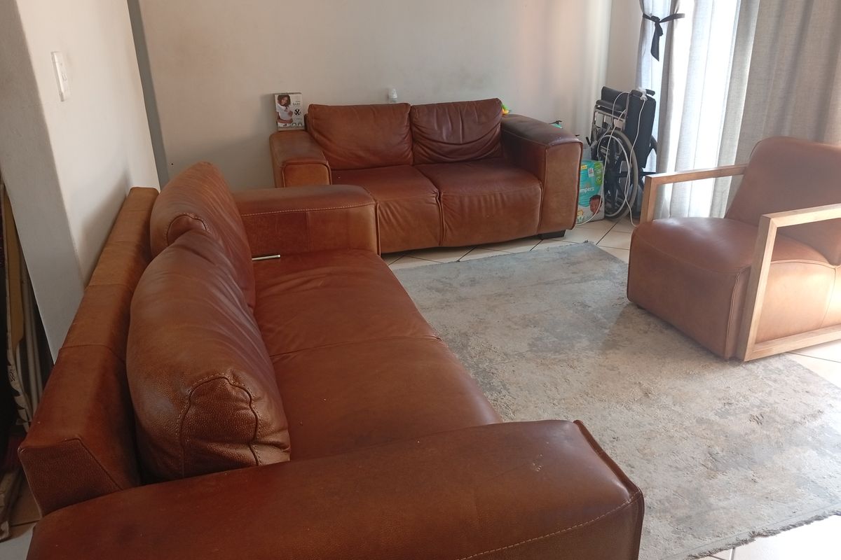 A living room area featuring tiled flooring and a sliding glass door providing natural light.