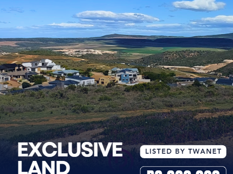 An elevated aerial view of the vacant residential land plot situated within the Outeniquasbosch estate, showcasing the surrounding landscape and neighborhood.