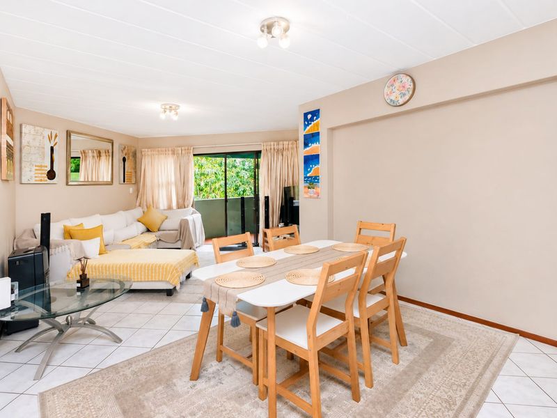 Open plan living and dining area featuring tiled flooring and a sliding glass door providing access to the balcony.