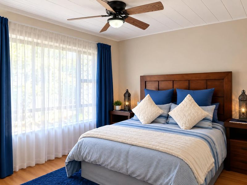 A well-maintained bedroom featuring a ceiling fan, tongue and groove ceiling, and timber-look flooring, offering a comfortable and inviting living space.