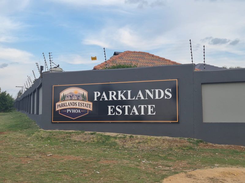 Exterior view of the Parklands Estate perimeter wall featuring secure electric fencing and estate signage.