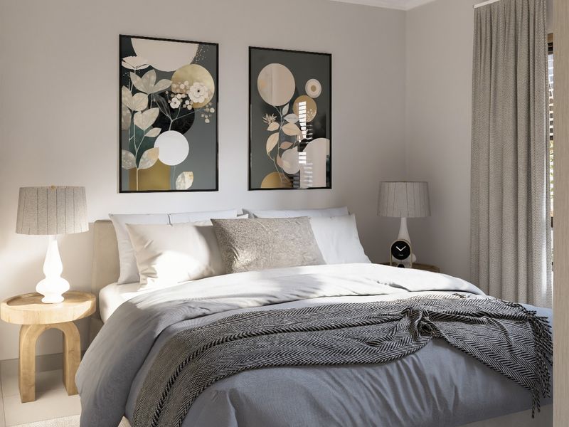 A well-lit bedroom featuring neutral wall tones and window treatments.