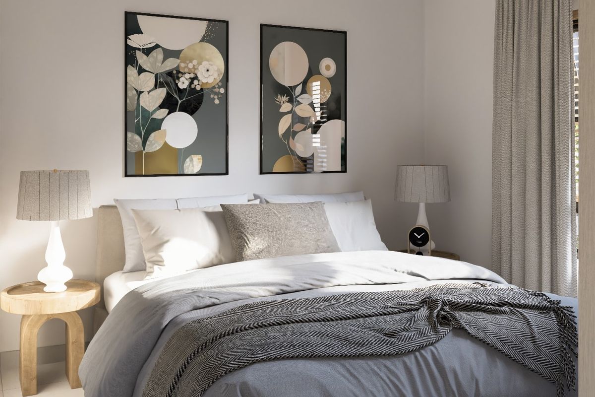 A well-lit bedroom featuring neutral wall tones and window treatments.