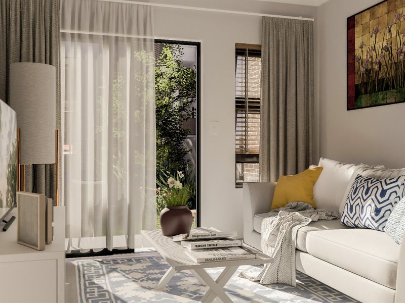 A bright and well-maintained living room featuring a large sliding glass door that provides natural light and access to the outdoor area.