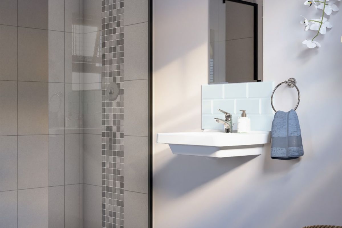Modern bathroom featuring a walk-in shower with a black-framed glass screen, mosaic tile accents, and a sleek wall-mounted basin with subway tile splashback.