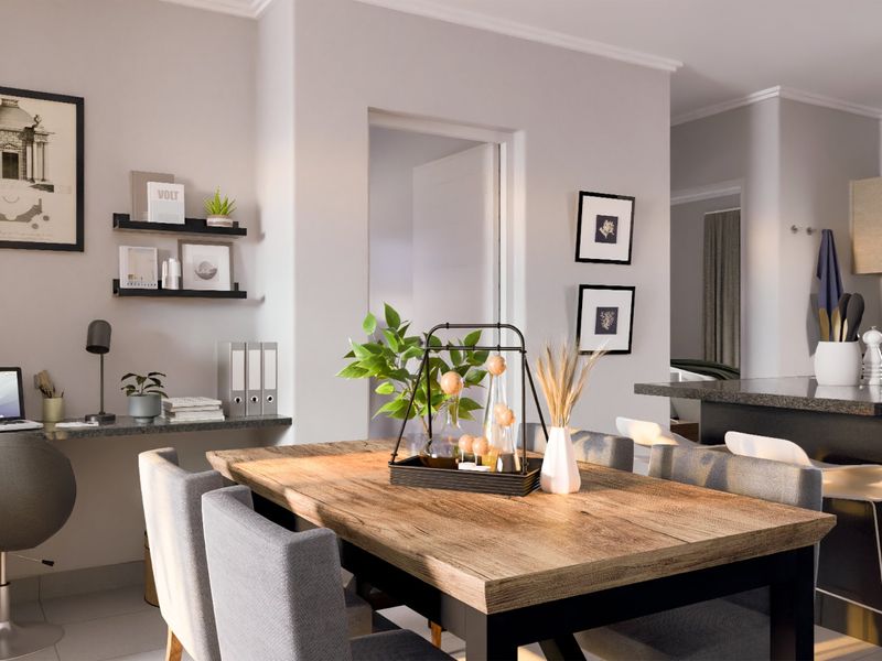 Modern open-plan living area featuring a built-in study nook, dining space, and a contemporary kitchen with stone countertops and breakfast bar seating.