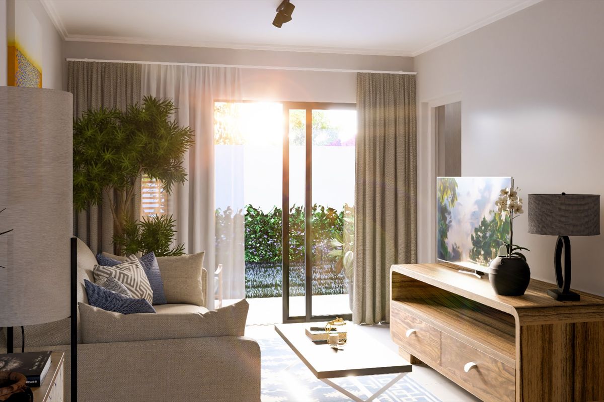 A bright and modern living room featuring a sliding glass door that opens to a private garden area, providing ample natural light.