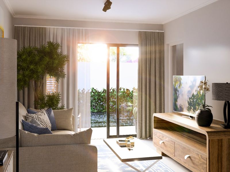 A bright and modern living room featuring a sliding glass door that opens to a private garden area, providing ample natural light.