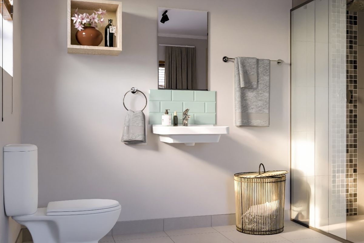A modern, well-lit bathroom featuring a wall-mounted basin with a tiled splashback, a glass-enclosed shower, and a standard toilet.