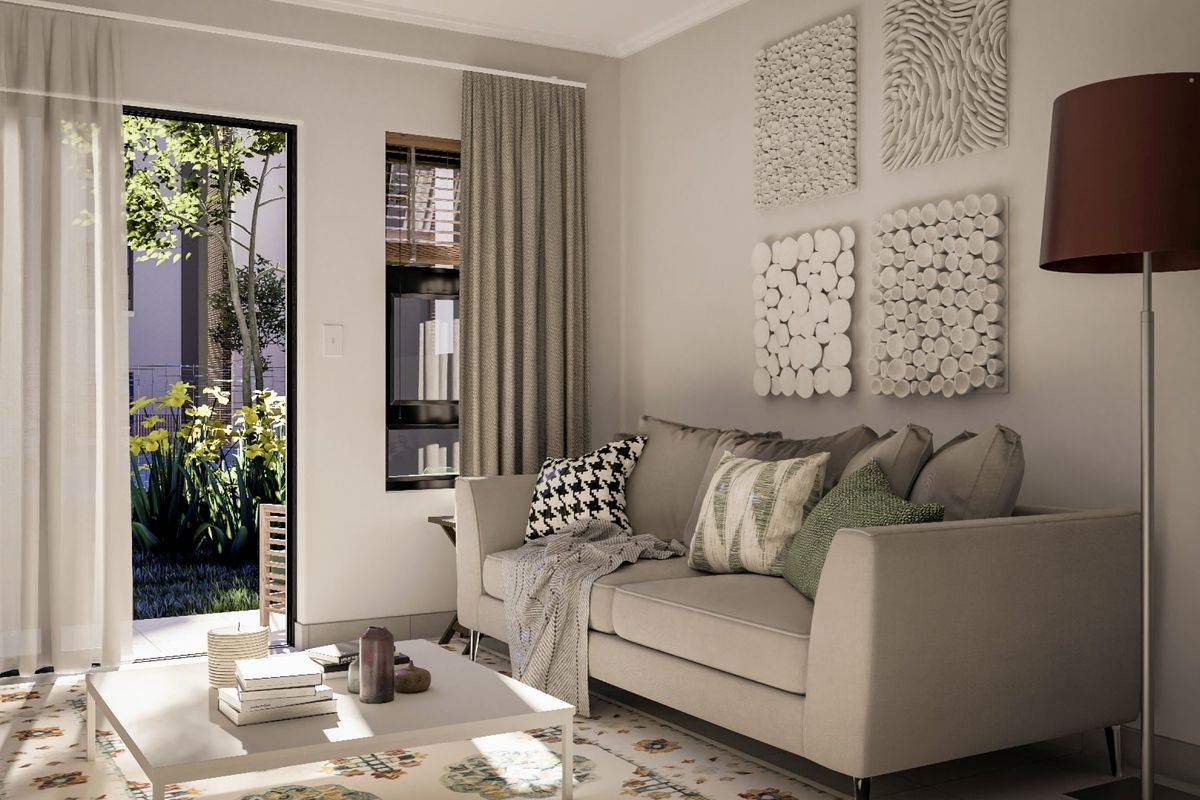 A bright and modern living room featuring a sliding glass door that opens to a private garden area, providing excellent natural light.