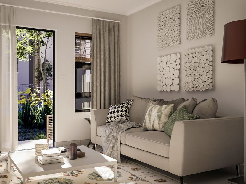 A bright and modern living room featuring a sliding glass door that opens to a private garden area, providing excellent natural light.