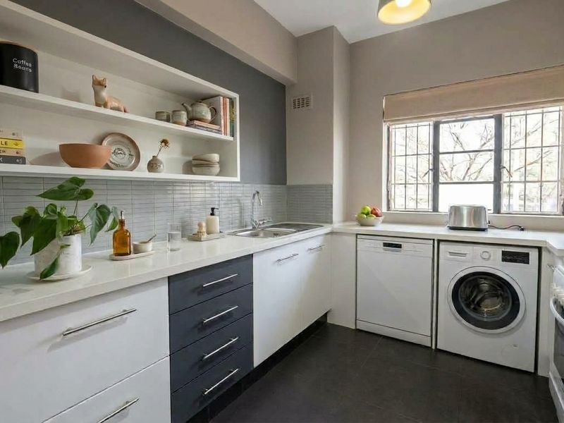 Modern kitchen featuring two-tone cabinetry, stone countertops, tiled backsplash, open shelving, and dedicated space for laundry and dishwashing appliances.