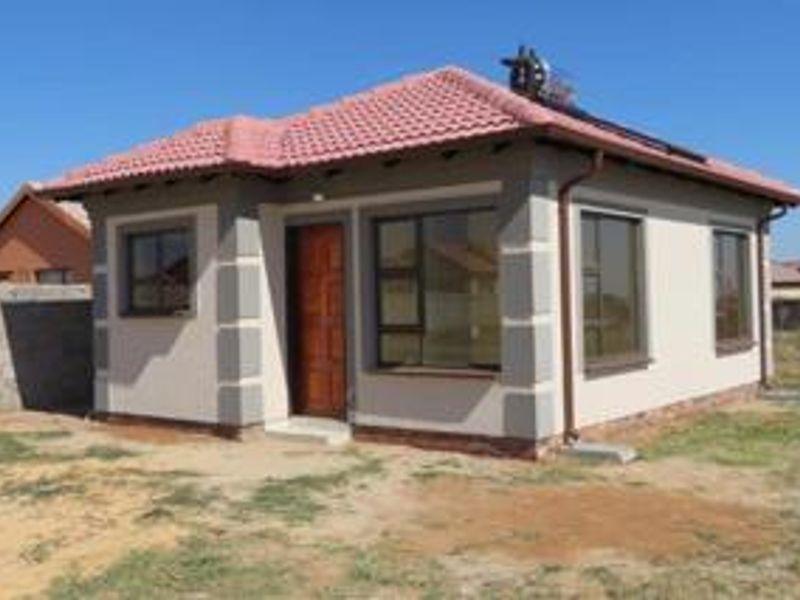 A well-maintained single-story detached house featuring a tiled roof, solar water heater, and modern aluminium window frames.