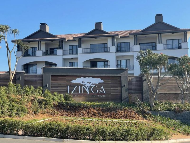 Front elevation of the Izinga Estate apartment complex, featuring modern architectural design, private balconies, and well-maintained landscaped grounds.