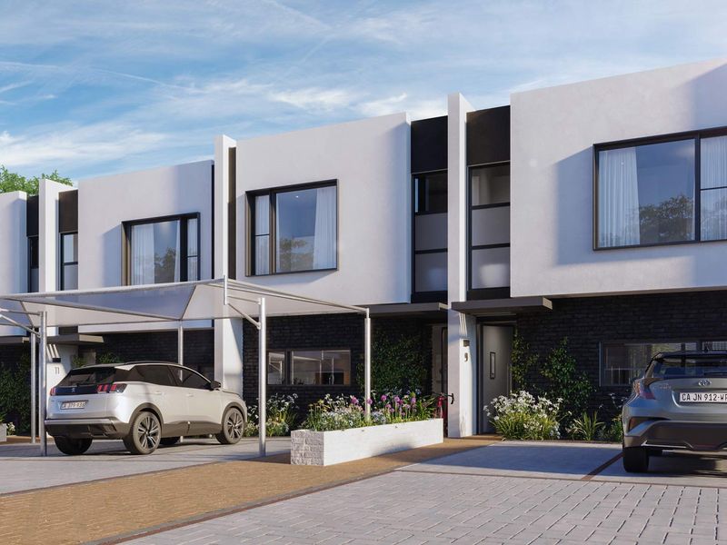 Modern apartment complex exterior featuring contemporary brick and white facade, paved driveway, and dedicated carport parking spaces.