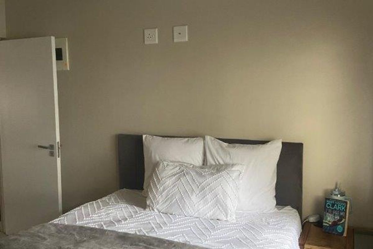 A well-maintained bedroom featuring neutral wall tones, recessed ceiling lighting, and standard internal door access.