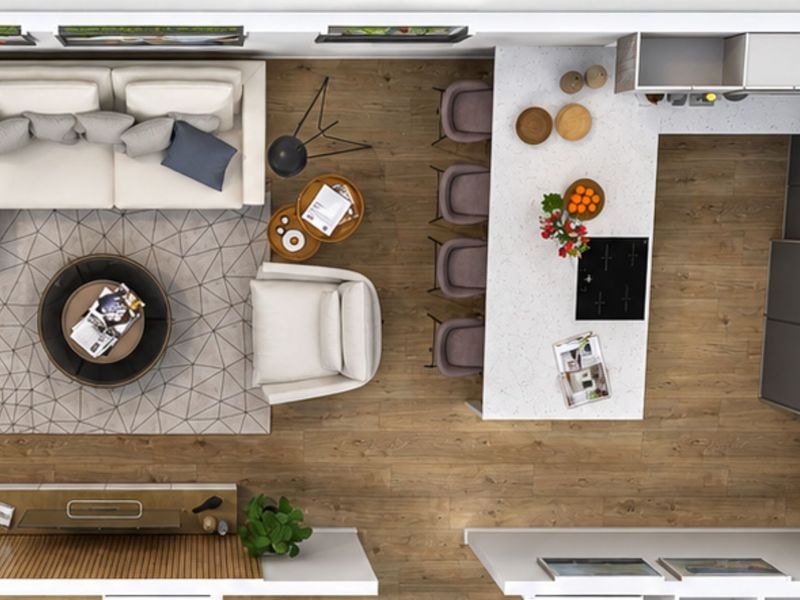 Top-down view of a modern open-plan living and kitchen area featuring a central island, integrated hob, and wood-look flooring.