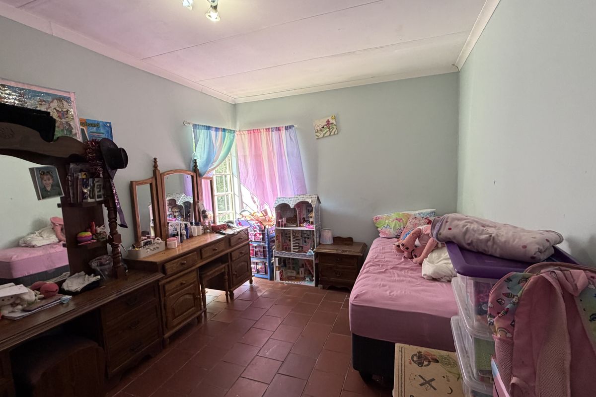A bedroom featuring tiled flooring and ceiling cornicing, offering a functional space ready for personalization.