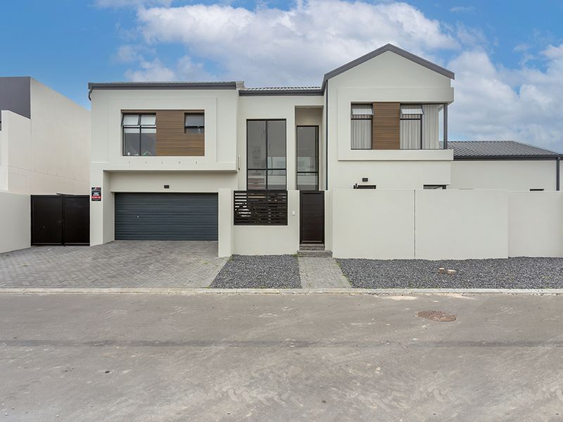 Modern double-storey residential property featuring a paved driveway, integrated double garage, and clean architectural lines with contemporary finishes.