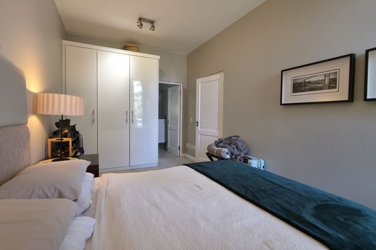 A well-maintained bedroom featuring a built-in wardrobe and direct access to an en-suite bathroom.