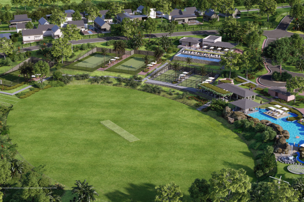 Aerial view of a residential estate featuring a cricket pitch, tennis courts, swimming pool, and clubhouse facilities within a landscaped environment.