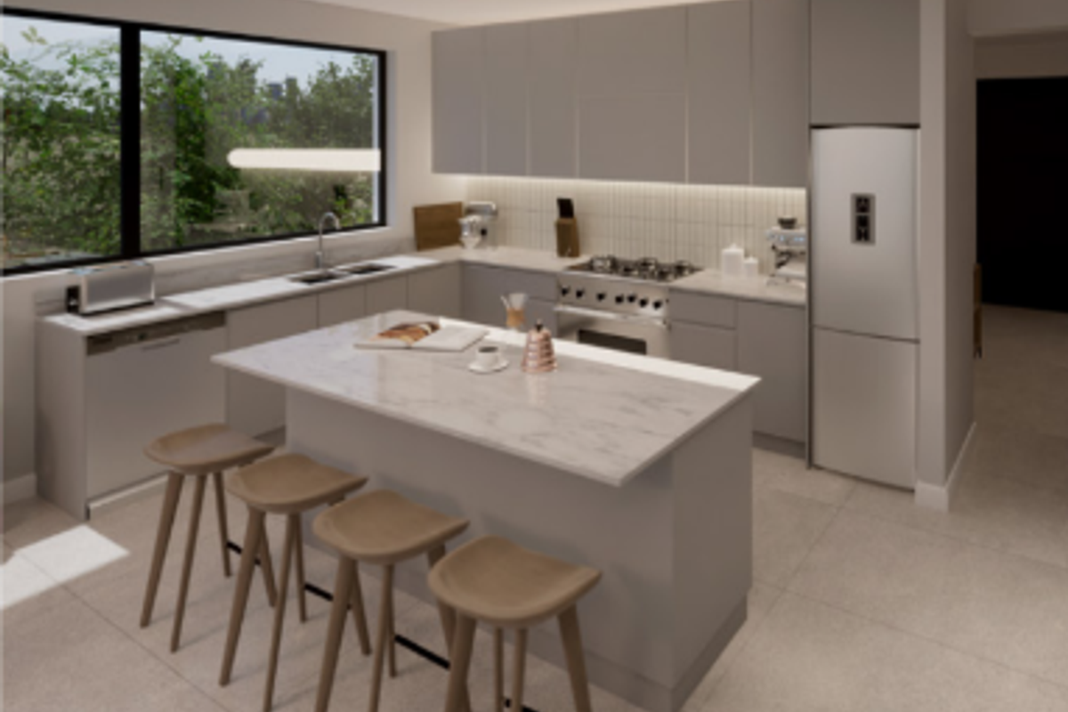 Modern kitchen featuring a central island with stone countertops, sleek cabinetry, integrated appliances, and a large window overlooking the exterior.