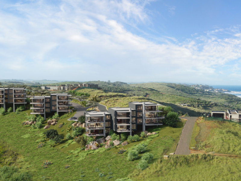 An aerial perspective of a modern coastal apartment development featuring multi-level residential blocks integrated into the hillside landscape.